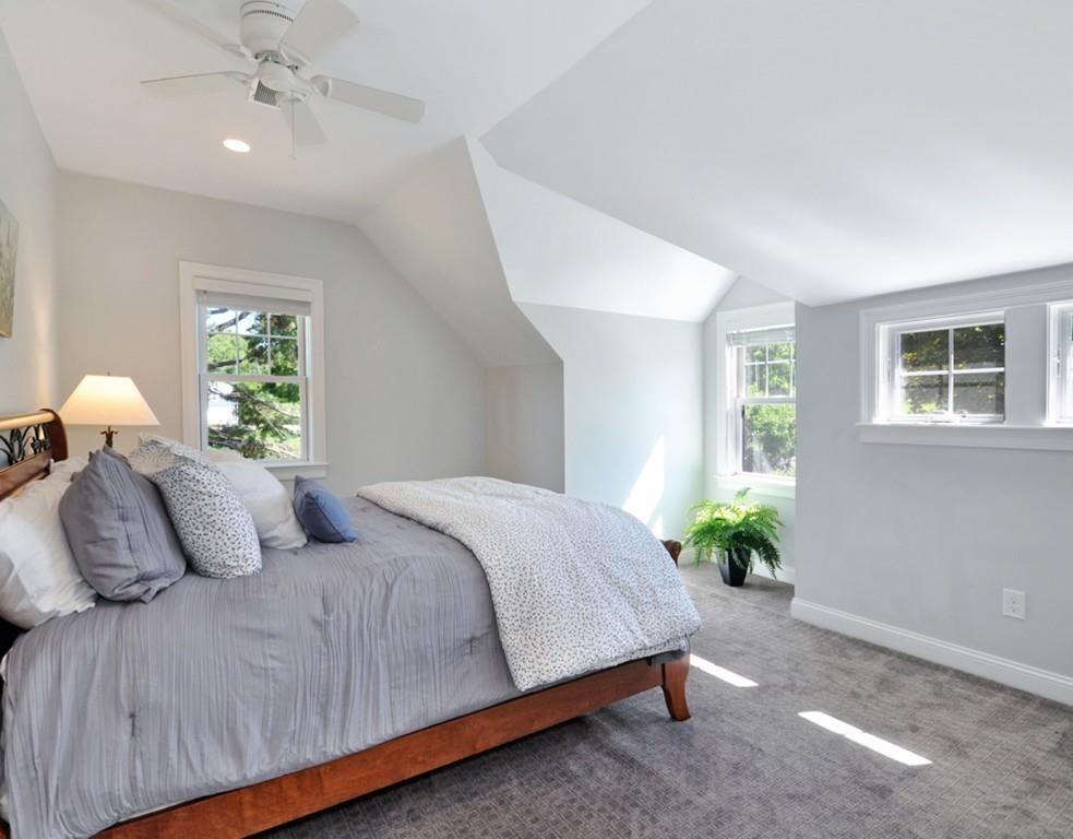 30 Nancy Road Concord, MA 01742 - Photo 18 of 26 a bedroom with a bed and a chandelier