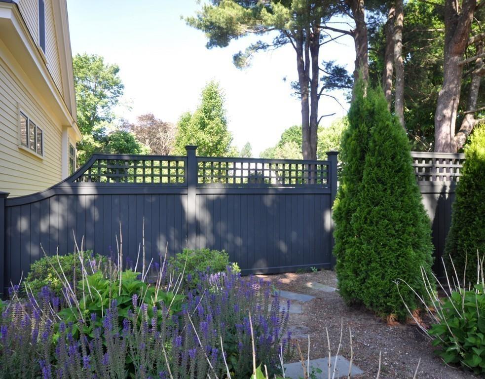 30 Nancy Road Concord, MA 01742 - Photo 22 of 26 a couple of table and chairs in front of a house