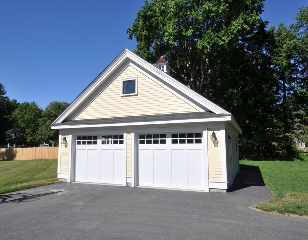 30 Nancy Road Concord, MA 01742 - Photo 25 of 26 a front view of a house with a yard and garage