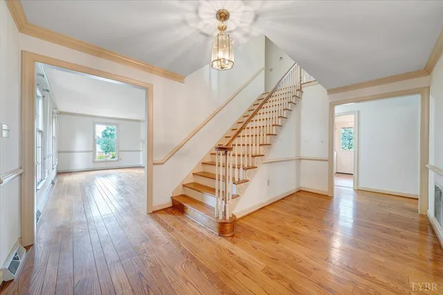 a view of entryway and hall with wooden floor