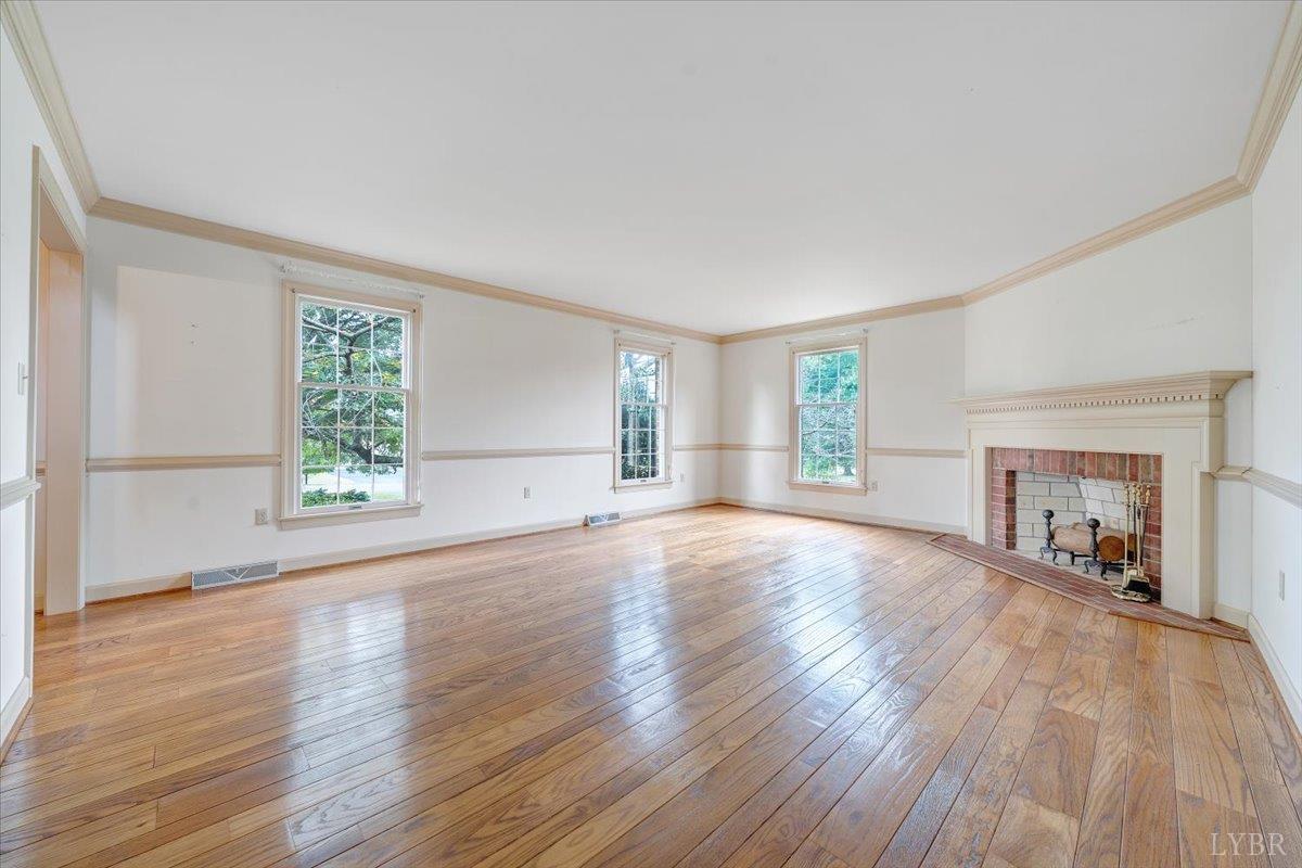 105 North Branch Road Bedford, VA 24523 - Photo 7 of 80 an empty room with wooden floor and windows