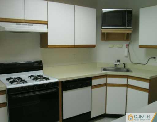 273 Prestwick Way Edison, NJ 08820 - Photo 2 of 6 a kitchen with stainless steel appliances a cabinets and a stove top oven