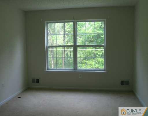 273 Prestwick Way Edison, NJ 08820 - Photo 3 of 6 a view of an empty room with a window