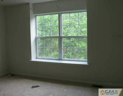 273 Prestwick Way Edison, NJ 08820 - Photo 6 of 6 a view of an empty room with a window