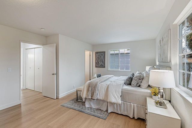 a bedroom with a bed and window