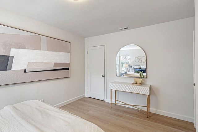 a view of room with furniture and wooden floor