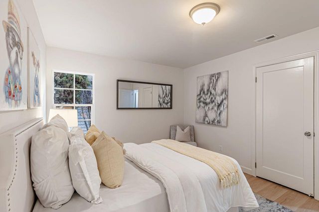 a bedroom with bed and a window