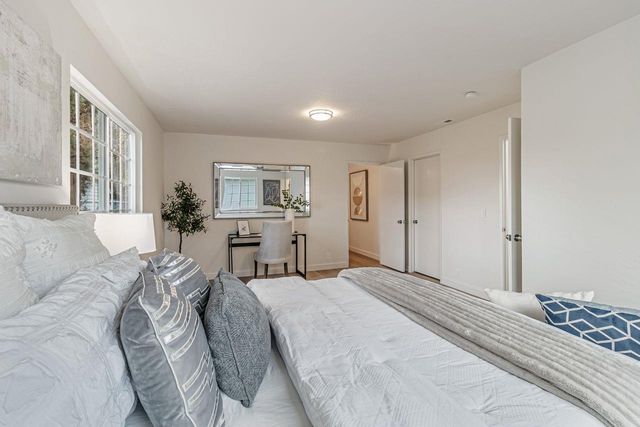 a spacious bedroom with a large bed and a window