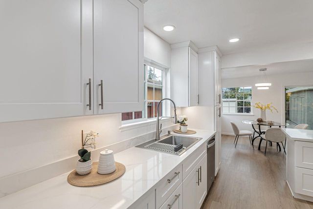 a kitchen with sink and chairs