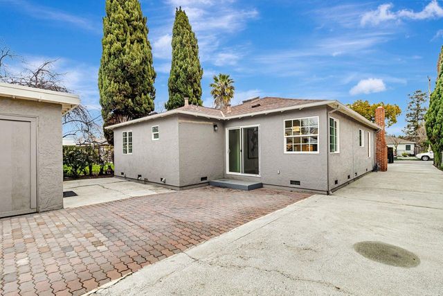 a view of a house with a yard and garage