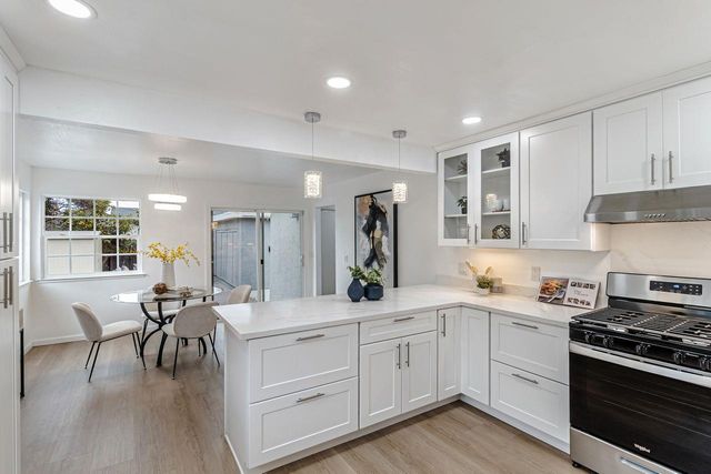 a kitchen with a sink stainless steel appliances and cabinets