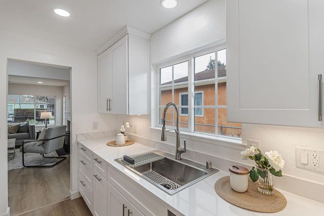 a kitchen with sink and a large window