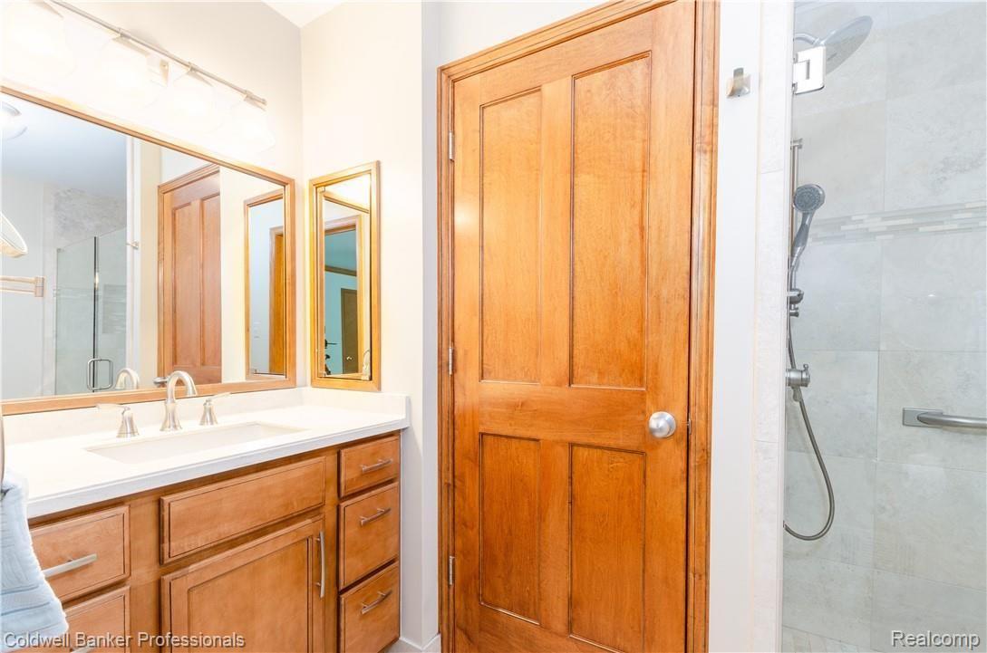 3388 Rivers Edge Drive, Unit 2 Wayne, MI 48184 - Photo 15 of 42 Master bath has newer ceramic tiled shower, vanity, fixtures and lighting.