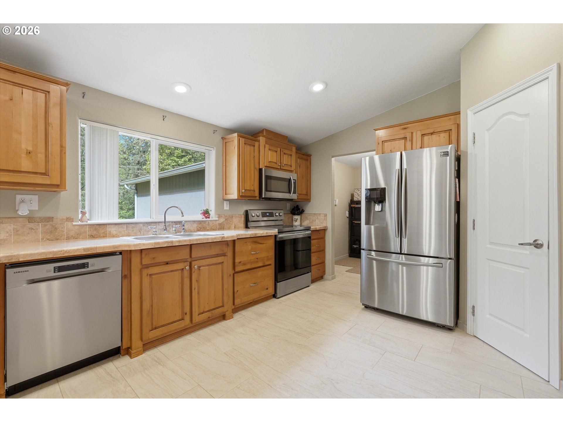 20270 Northwest Pihl Road Banks, OR 97106 - Photo 16 of 47 a kitchen with stainless steel appliances a refrigerator sink and cabinets