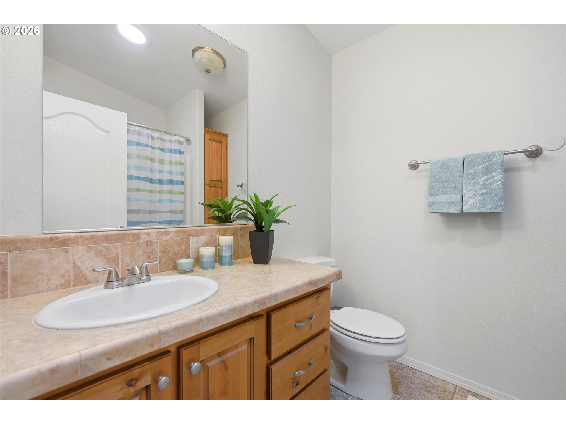20270 Northwest Pihl Road Banks, OR 97106 - Photo 35 of 47 a bathroom with a granite countertop sink a toilet and a mirror