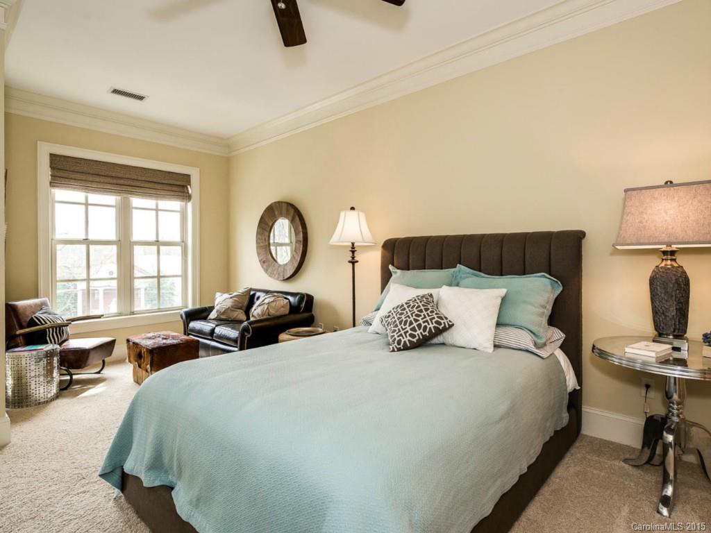 2823 Providence Road, Unit 145 Charlotte, NC 28211 - Photo 12 of 24 a bedroom with bed and a tv on dresser