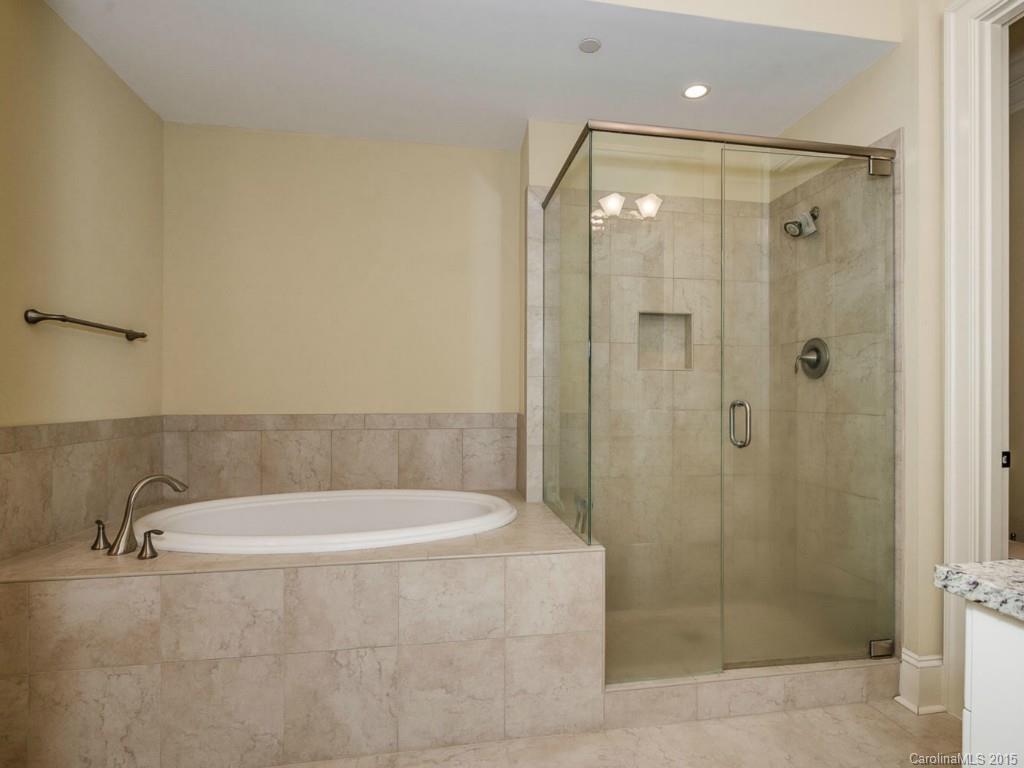 2823 Providence Road, Unit 145 Charlotte, NC 28211 - Photo 13 of 24 a white bath tub sitting next to a shower