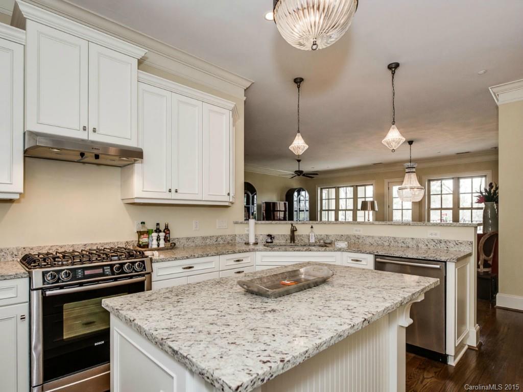 2823 Providence Road, Unit 145 Charlotte, NC 28211 - Photo 6 of 24 a kitchen with granite countertop a sink stove and cabinets
