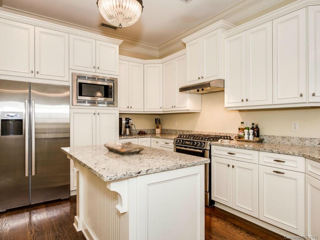 2823 Providence Road, Unit 145 Charlotte, NC 28211 - Photo 7 of 24 a kitchen with granite countertop white cabinets and stainless steel appliances