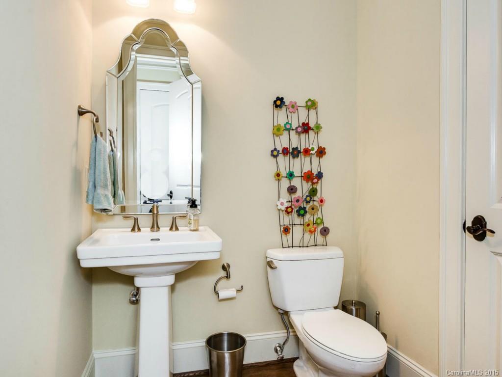2823 Providence Road, Unit 145 Charlotte, NC 28211 - Photo 8 of 24 a bathroom with a sink a toilet and a mirror