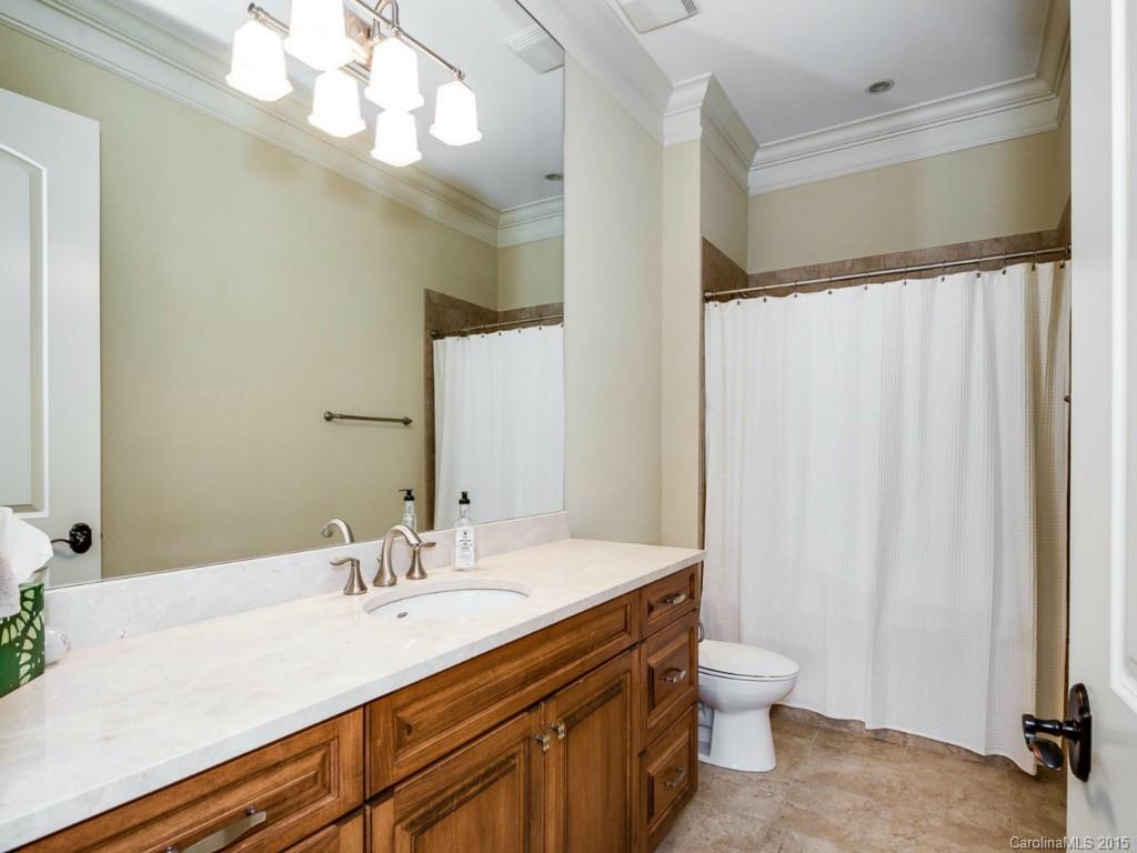 2823 Providence Road, Unit 145 Charlotte, NC 28211 - Photo 9 of 24 a bathroom with a sink a toilet and a mirror