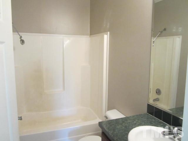 728 Woodys Store Road Roxboro, NC 27574 - Photo 14 of 15 a bathroom with a granite countertop bathtub shower sink and toilet