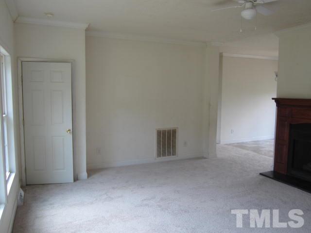 728 Woodys Store Road Roxboro, NC 27574 - Photo 7 of 15 an empty room with a fireplace