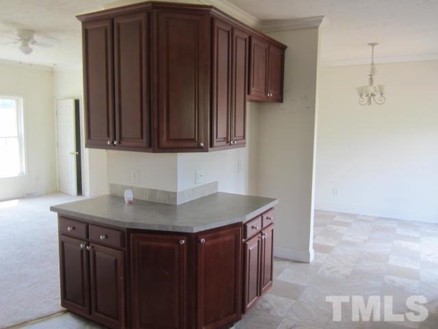 728 Woodys Store Road Roxboro, NC 27574 - Photo 9 of 15 a kitchen with a sink cabinets and wooden floor