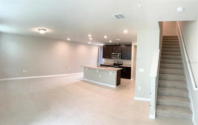 a view of kitchen with kitchen island microwave and stove