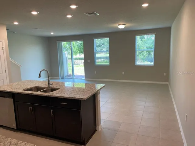 a swimming pool with an outdoor space and seating