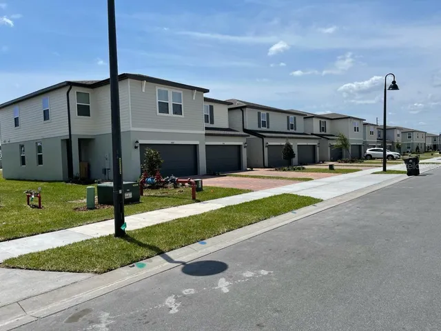a view of a house with sitting area and swimming pool