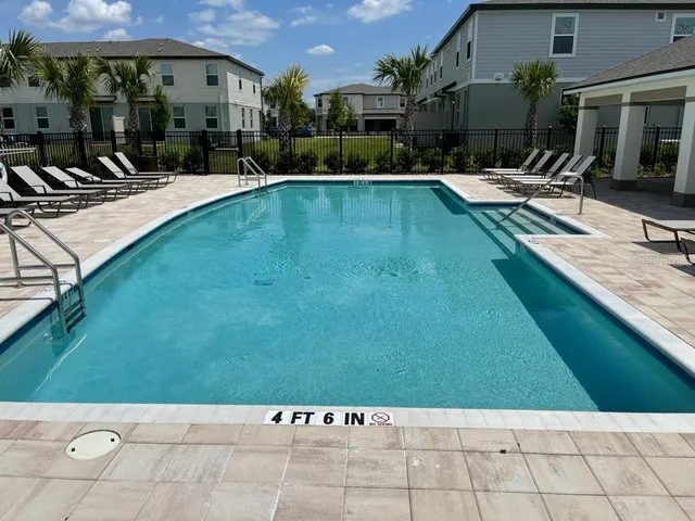 a view of a swimming pool with a chair