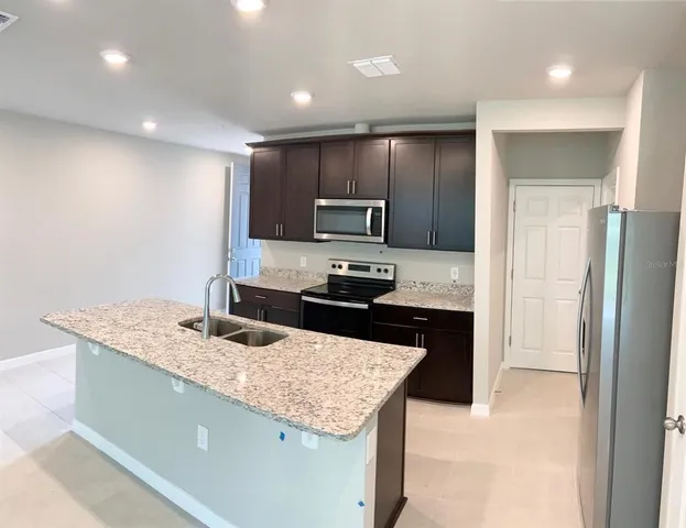 a kitchen with granite countertop cabinets and stainless steel appliances