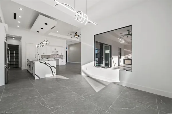a kitchen with a refrigerator a sink and cabinets