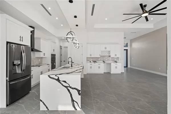 a kitchen with stainless steel appliances a stove a sink and a refrigerator
