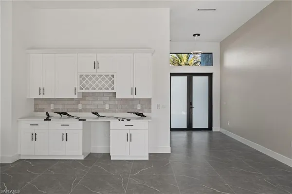 a large kitchen with cabinets and stainless steel appliances