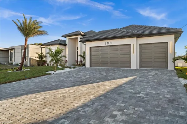 a front view of a house with a yard and garage