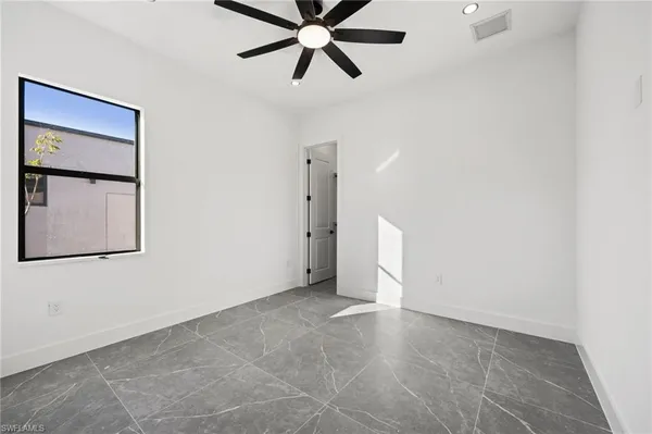 a view of a livingroom with a ceiling fan and window