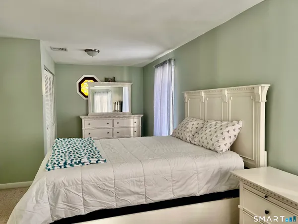 a bedroom with a bed and a cabinets