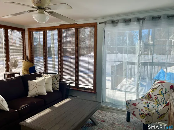 a living room with furniture and a floor to ceiling window