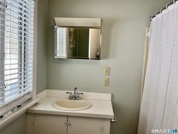 a bathroom with a sink and a mirror