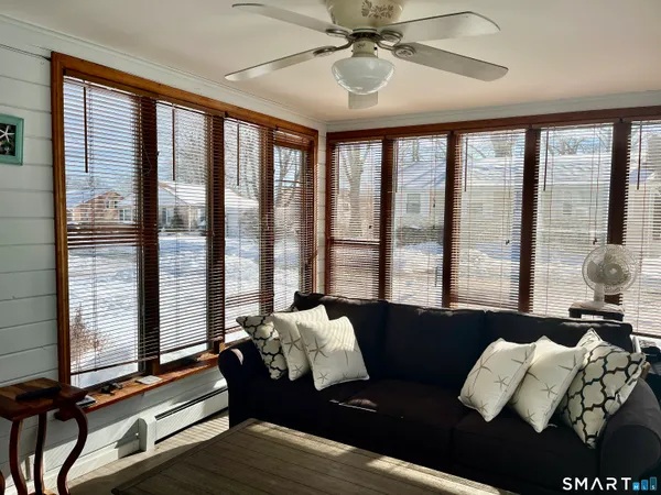 a living room with furniture and floor to ceiling windows