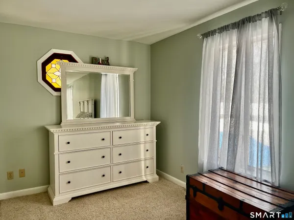 a room with a dresser and a mirror