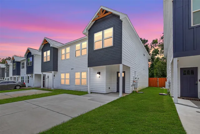 a front view of a house with a garden and yard