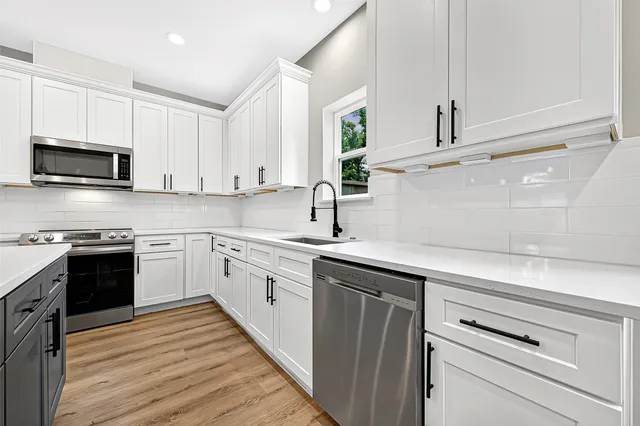 a kitchen with appliances cabinets and a sink