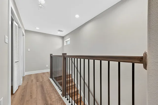 a view of a hallway with wooden floor