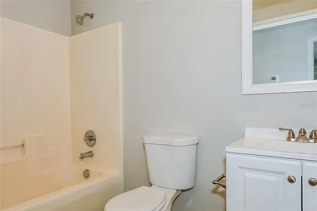 a white toilet sitting next to a bathroom sink
