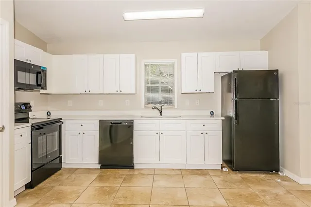 a kitchen with a refrigerator stove and sink