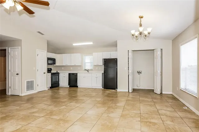 a view of a kitchen with a stove cabinets and a kitchen