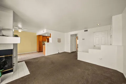 a view of empty room with a fireplace